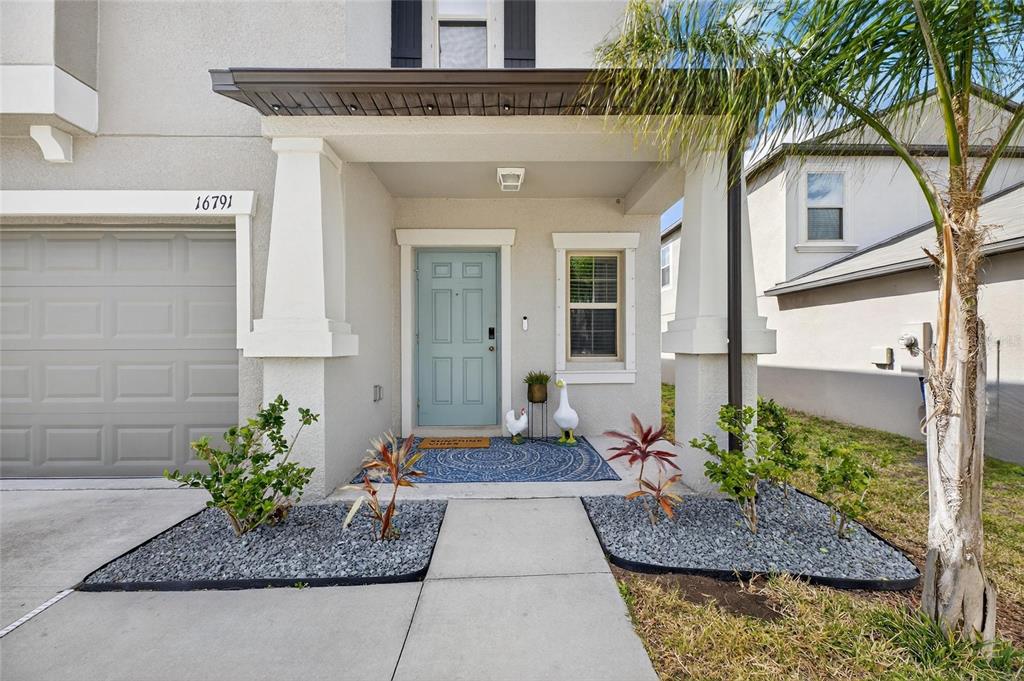 A kitchen with white cabinets, granite countertops, a center island, and tile flooring — 16791 DELIA STREET, WIMAUMA, FL
