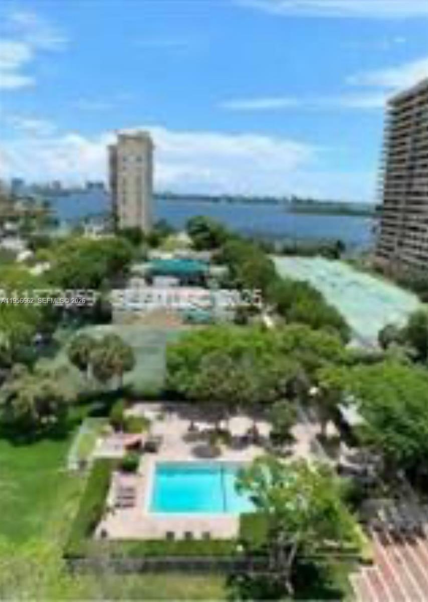 An elevated view shows a swimming pool, tennis courts, and a high-rise building near water — 11111 Biscayne Blvd # 4D, Miami FL 33181, MIAMI, FL