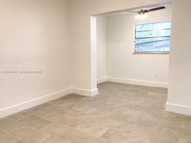 An interior view shows a room with light-colored tile flooring and white walls — 2194 NW 18th Ter # 0, Miami FL 33125, MIAMI, FL