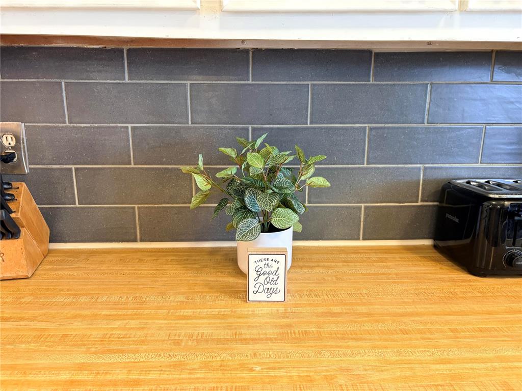 A kitchen counter features a small potted plant and a decorative sign against a backsplash — 2790 INDIANWOOD DRIVE, NORTH FORT MYERS, FL