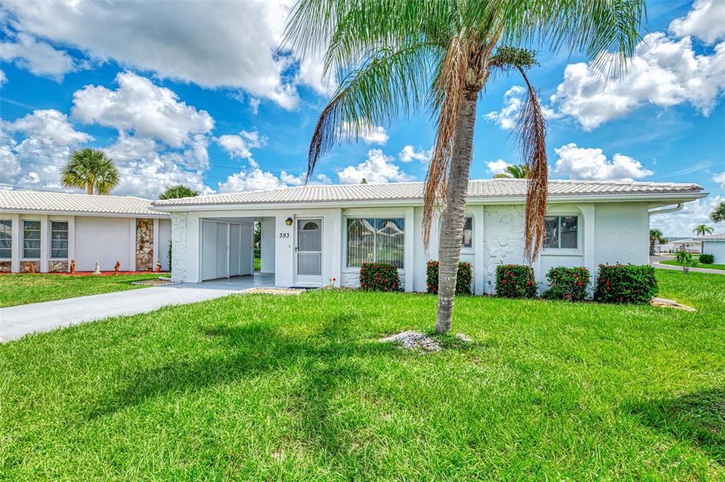 A white single-story house with a palm tree in the front yard — 393 CIRCLEWOOD DRIVE UNIT Z3, VENICE, FL