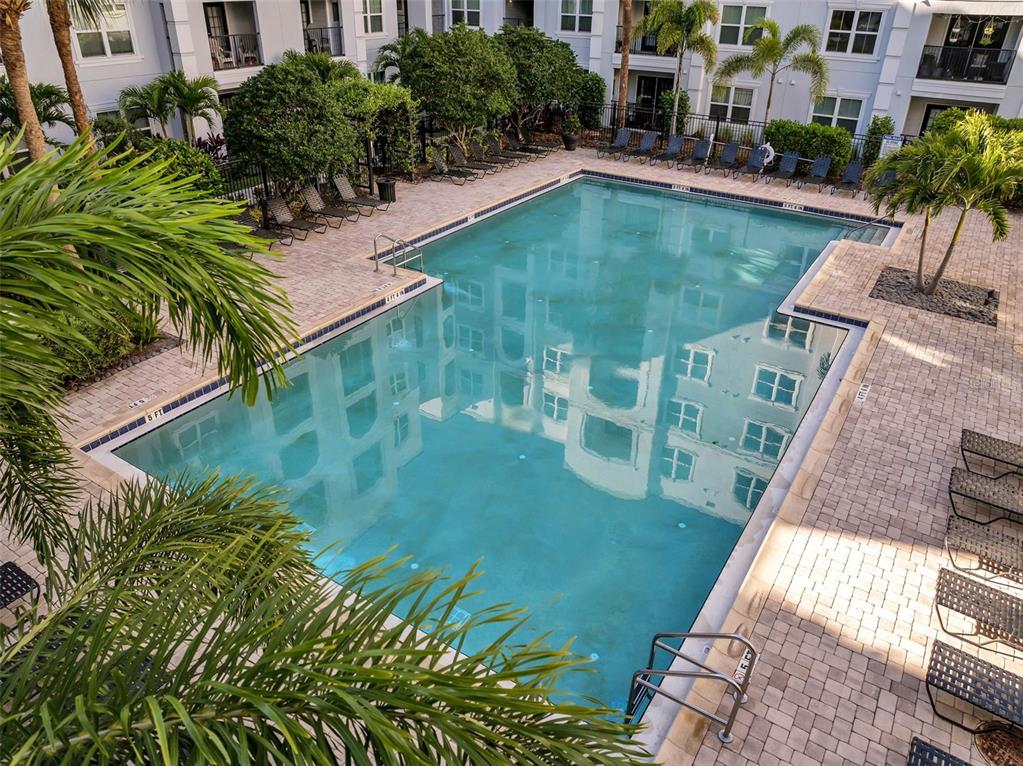 A multi-story apartment building features a gated arched driveway entrance and light-colored exterior walls — 300 E SOUTH STREET UNIT 1003, ORLANDO, FL