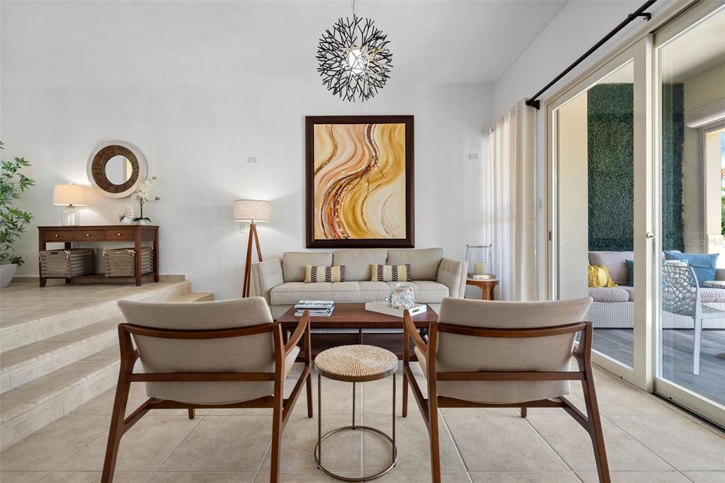 A living room features a sofa, two armchairs, a coffee table, and a sliding glass door — 90 CANDELERO DRIVE UNIT 62, HUMACAO, PR