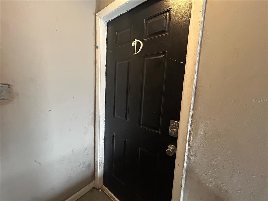 A black door marked with the letter D is set in a plain interior wall — 2773 L B MCLEOD ROAD UNIT 2773D, ORLANDO, FL