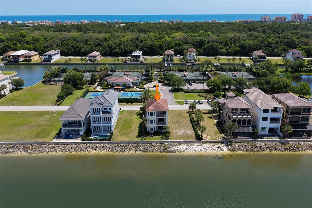 An aerial view shows a multi-story house with a terracotta roof along a waterfront — 224 YACHT HARBOR DRIVE, PALM COAST, FL