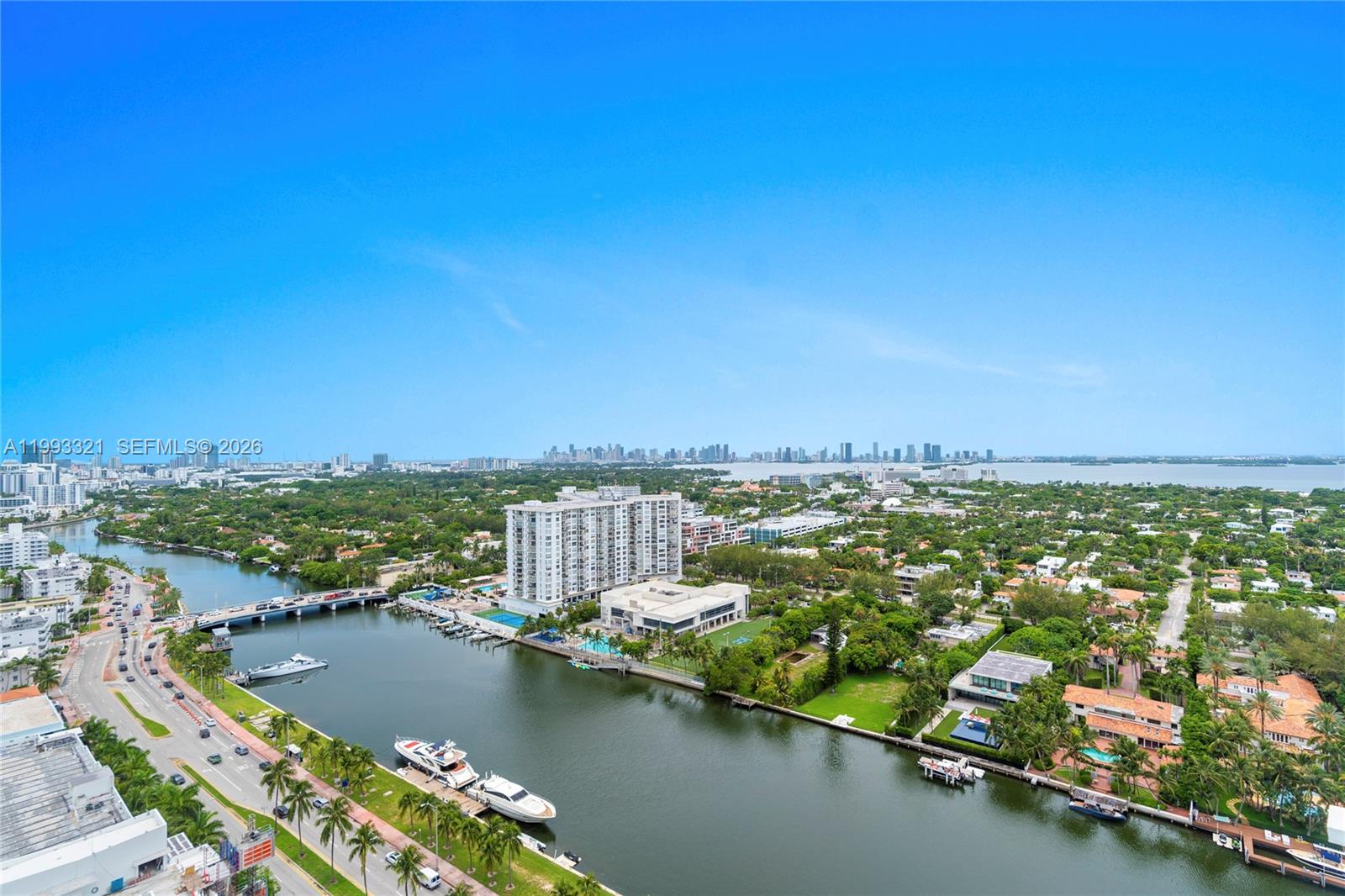An aerial view shows a waterway with yachts, a bridge, and surrounding residential buildings — 4401 Collins Ave, Miami Beach FL 33140, MIAMI BEACH, FL