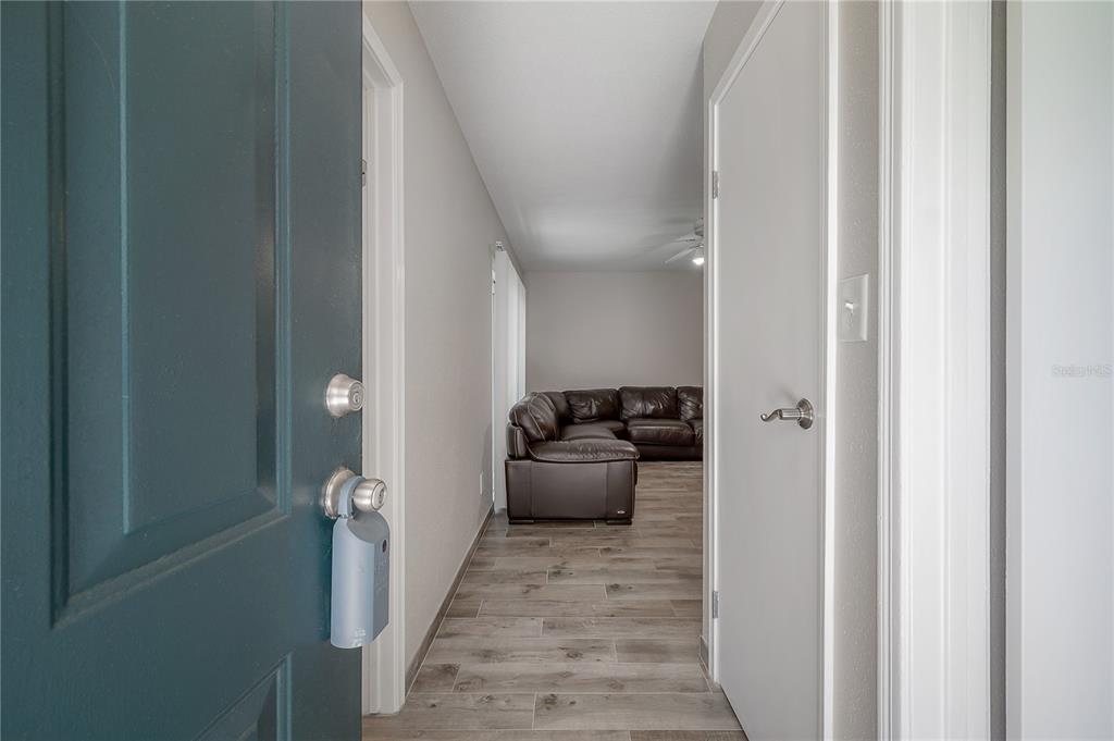 A view from an open doorway into a hallway with wood-look tile flooring — 9100 DR MARTIN LUTHER KING JR STREET N UNIT 905, ST PETERSBURG, FL