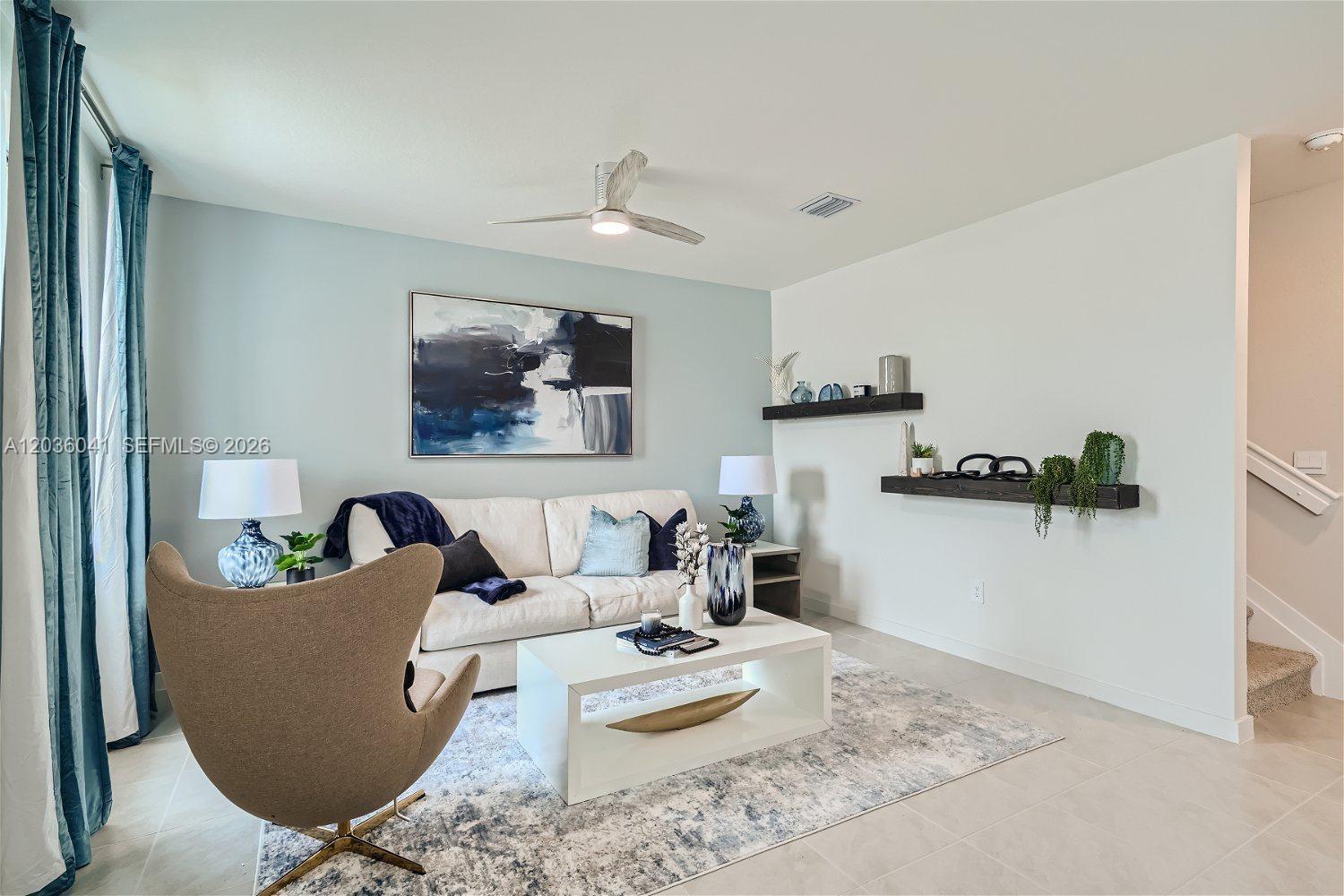 A living room features a white sofa, a tan accent chair, and two floating shelves — 1366 NE 4th Ave, Florida City FL 33034, FLORIDA CITY, FL