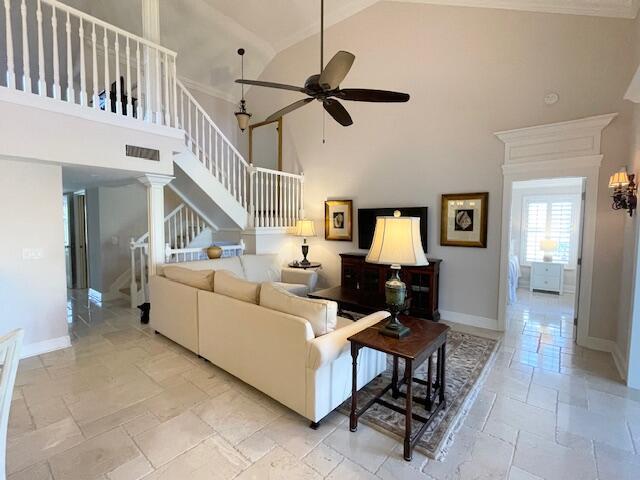A living room features a white sectional sofa, a vaulted ceiling, and a staircase — 2502 N Fairway Dr Drive N, Jupiter FL 33477, JUPITER, FL