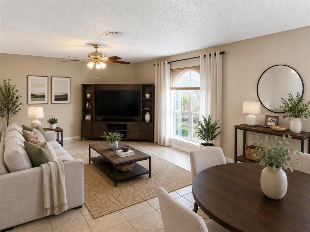 A living room with a sofa, wooden coffee table, media console, and a dining area — 510 LOBELIA DRIVE, DAVENPORT, FL