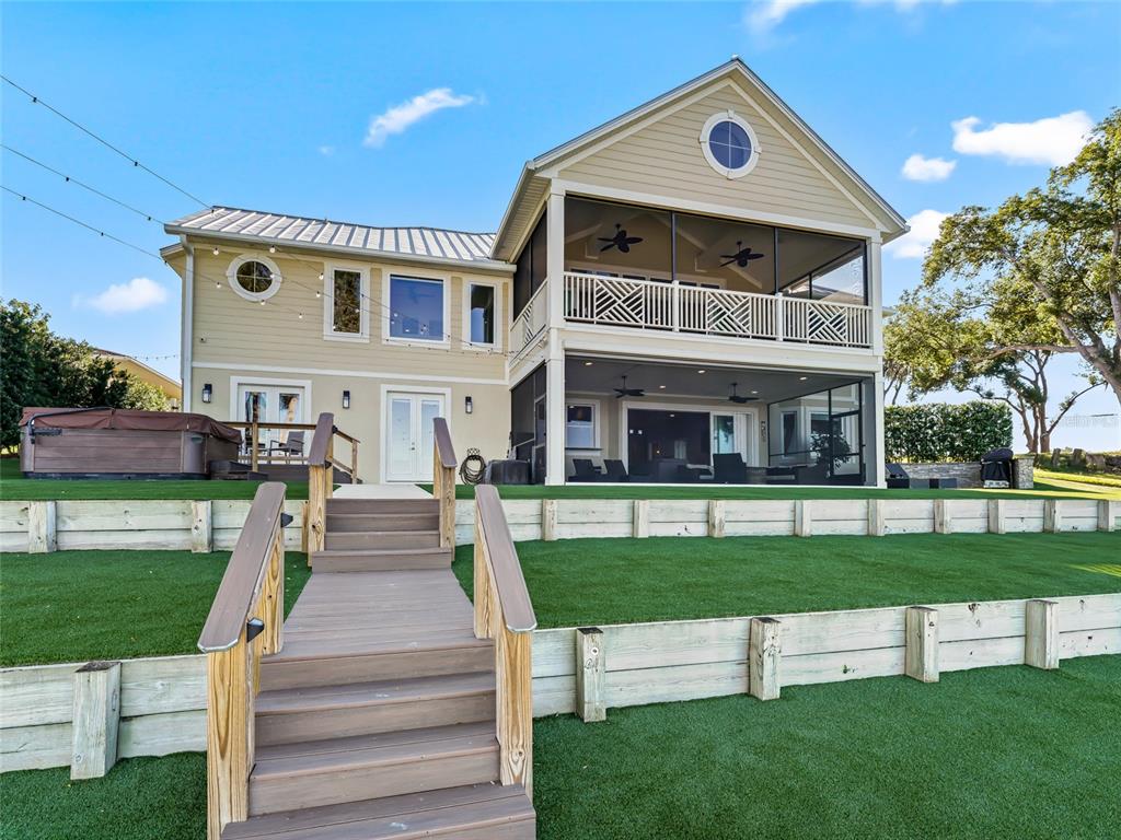 An aerial view shows a waterfront house with two docks on a large lake — 12943 SE SUNSET HARBOR ROAD, WEIRSDALE, FL