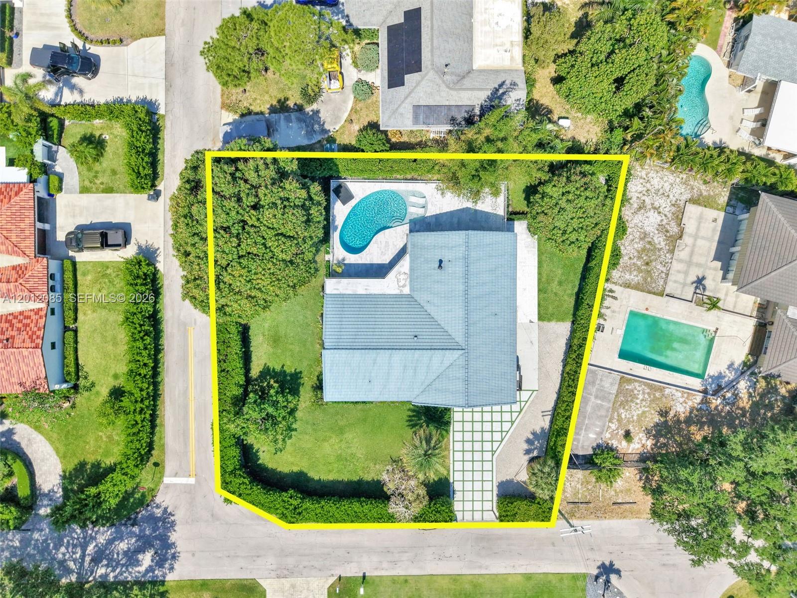 An aerial view shows a house with a pool, large yard, and driveway within a lot — 1001 NW 4th Ct, Boca Raton FL 33432, BOCA RATON, FL