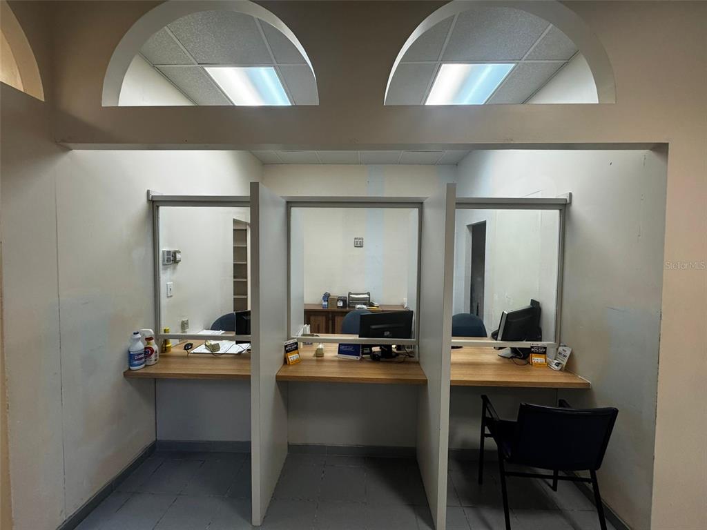 A commercial office space features three partitioned workstations with glass windows and wooden desks — 204 CALLE JULIO CINTRON, AIBONITO, PR