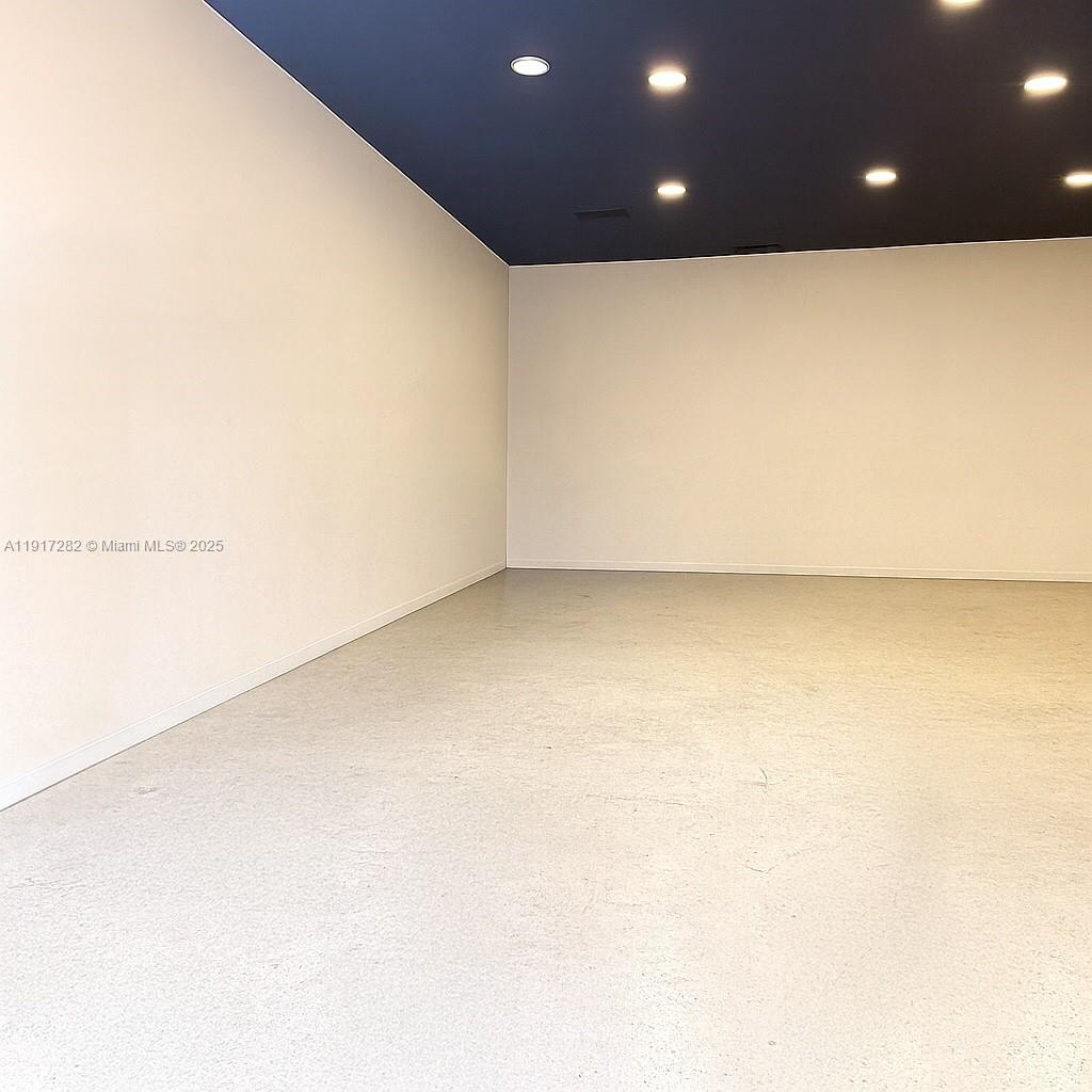 An empty room features white walls, a dark blue ceiling with recessed lighting, and flooring — 5798 SW 8th St, West Miami FL 33144, WEST MIAMI, FL