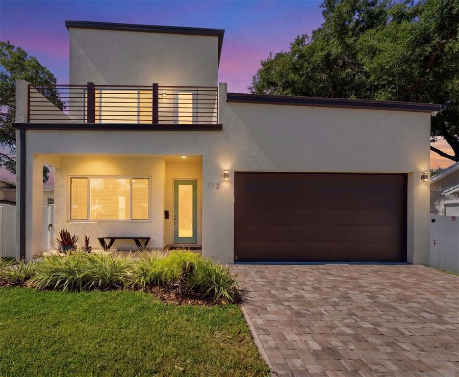A modern two-story house features a flat roof, a balcony, and a paved driveway — 112 W SLIGH AVENUE, TAMPA, FL