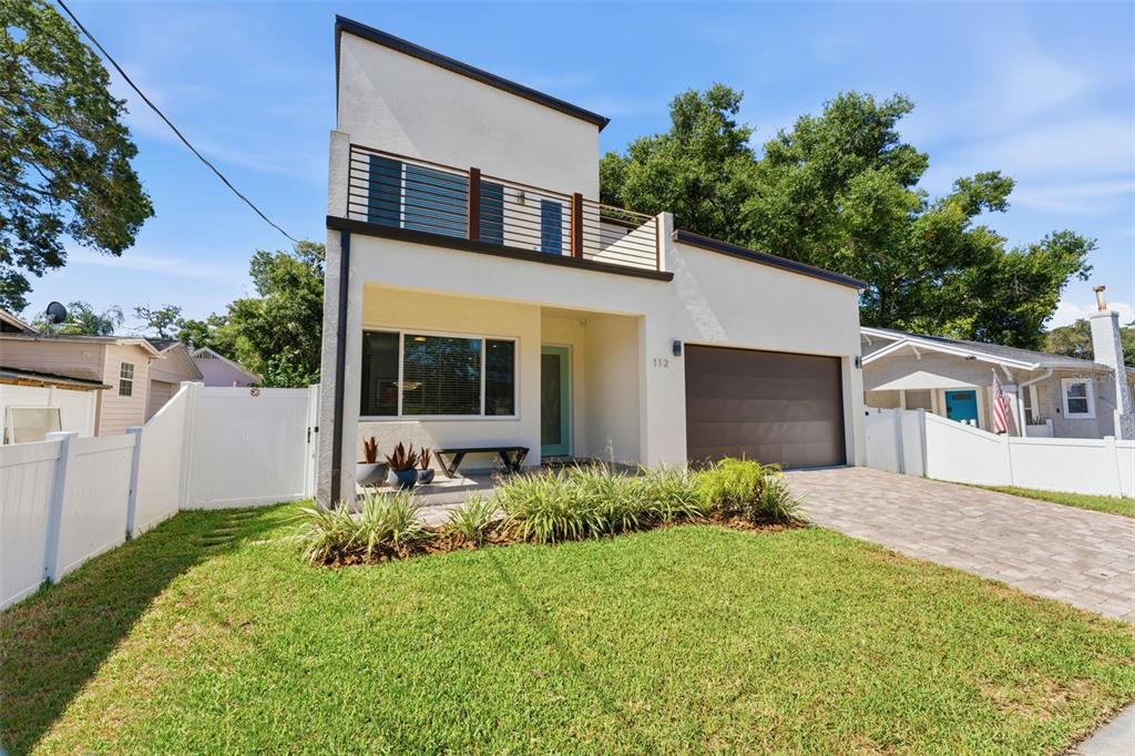 A modern two-story house features a flat roof, a balcony, and a paved driveway — 112 W SLIGH AVENUE, TAMPA, FL