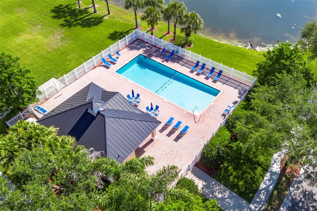 An aerial view of a rectangular swimming pool with a pavilion and lounge chairs — 7534 15TH LANE, VERO BEACH, FL