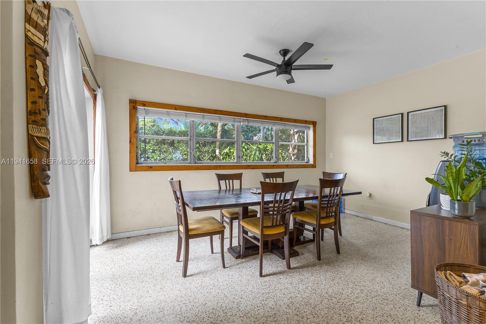 A dining room features a wooden table with six chairs, a ceiling fan, and windows — 325 Bird Rd, Coral Gables FL 33146, CORAL GABLES, FL