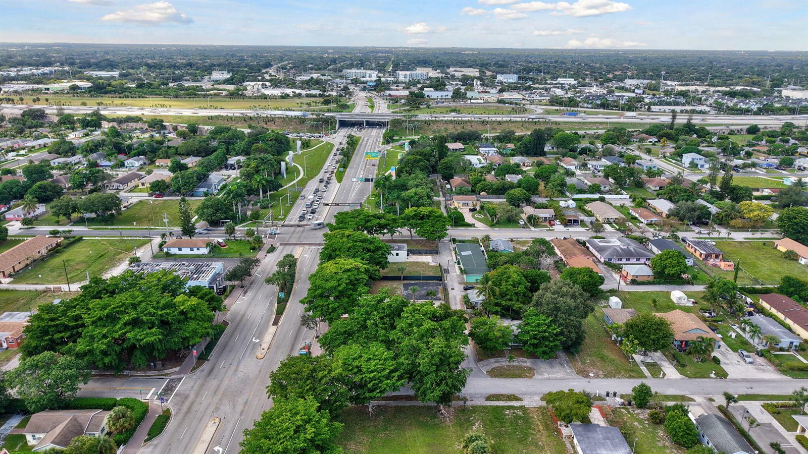 An aerial view shows a residential neighborhood with a major highway overpass in the distance — 0 W Atlantic Avenue, Delray Beach FL 33444, DELRAY BEACH, FL