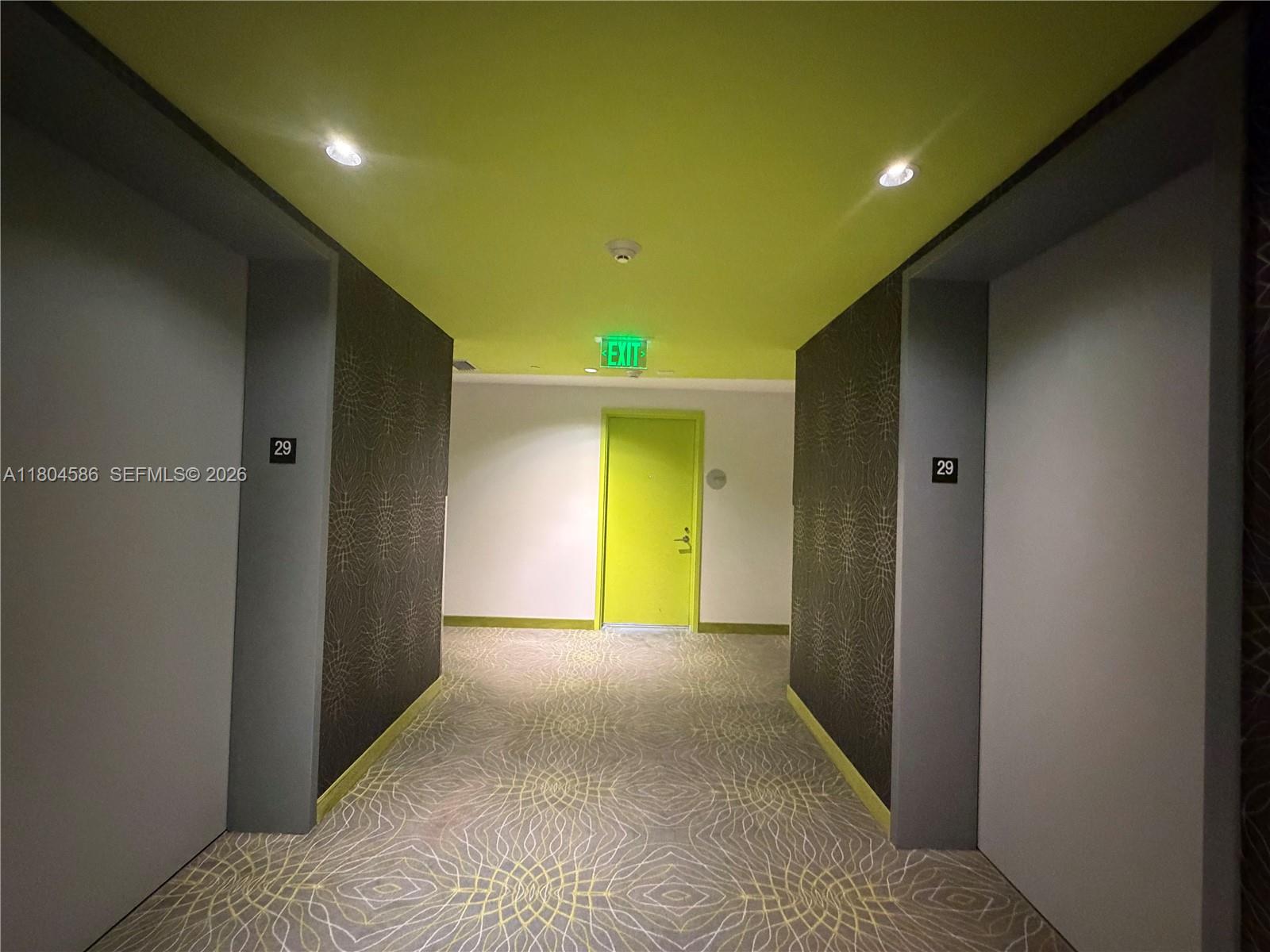 A hallway features patterned wallpaper, a lime green ceiling, and a matching green exit door — 501 NE 31st St # 2903, Miami FL 33137, MIAMI, FL