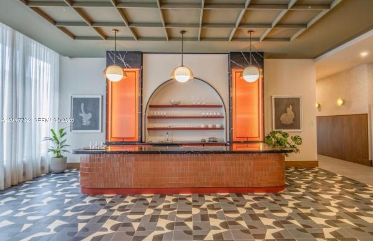 A modern bar area features a tiled counter, arched shelving, and a coffered ceiling — 11 NE 6th St # 213, Miami FL 33132, MIAMI, FL