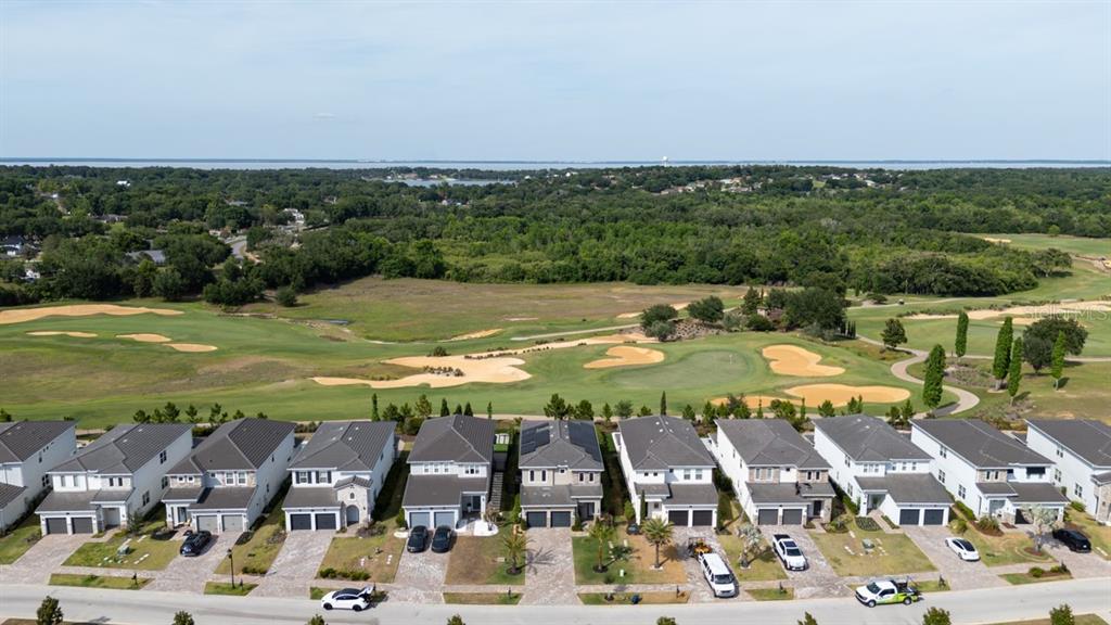 A two-story suburban house features a two-car garage, stone accents, and a paved driveway — 15717 VETTA DRIVE, MONTVERDE, FL