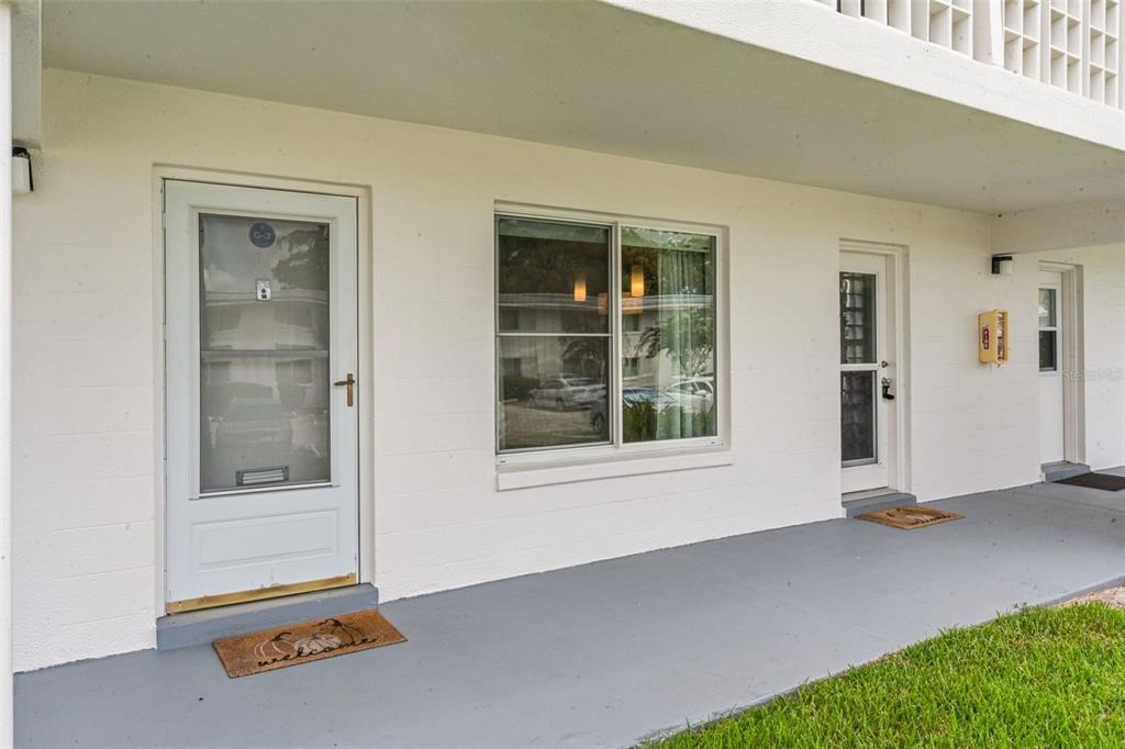 A white exterior building facade with two doors, a window, and a gray concrete walkway — 1140 S ORLANDO AVENUE UNIT G-3, MAITLAND, FL