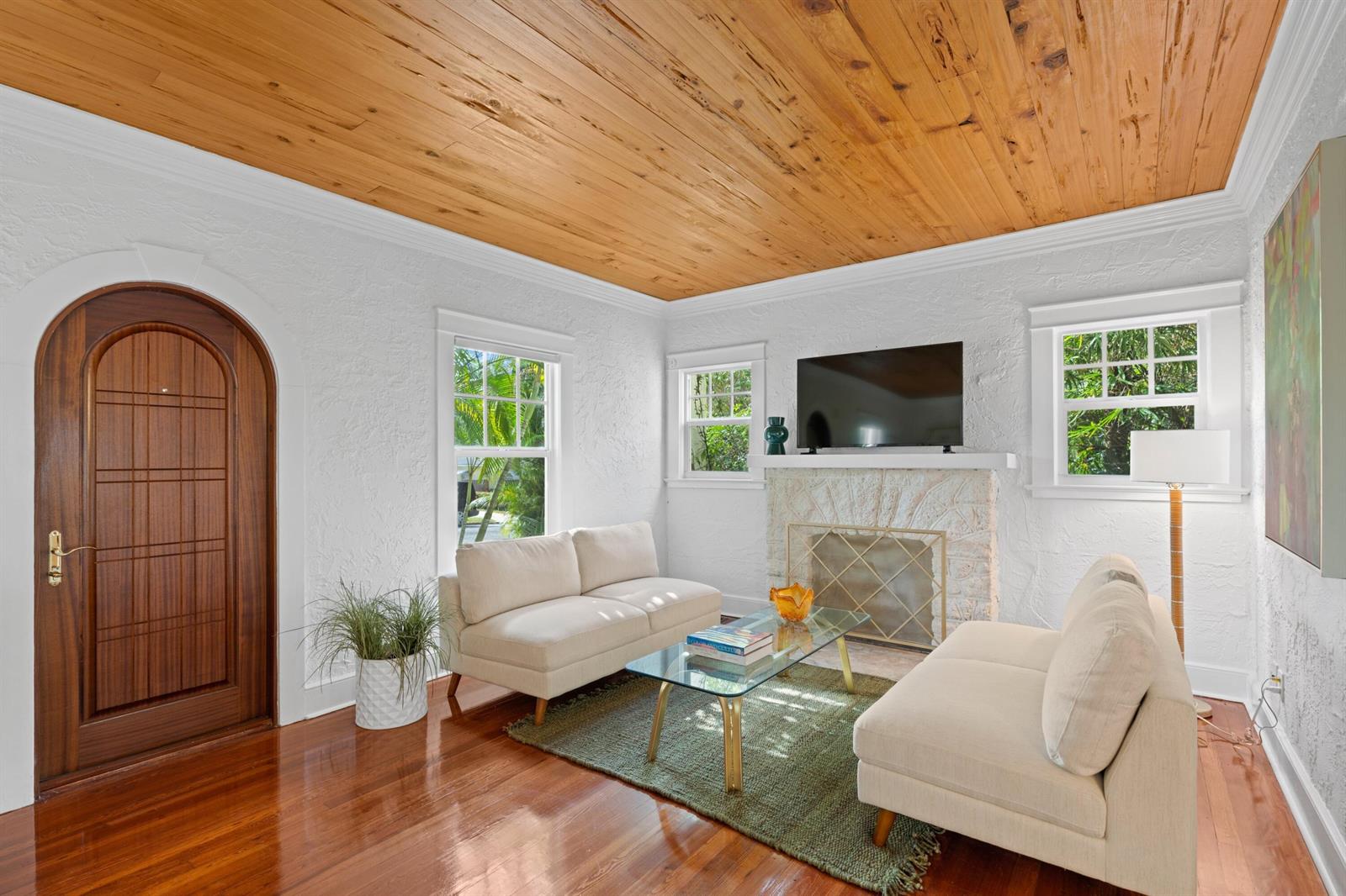 A living room features a wood-plank ceiling, white textured walls, a fireplace, and two sofas — 727 Claremore Drive, West Palm Beach FL 33401, WEST PALM BEACH, FL
