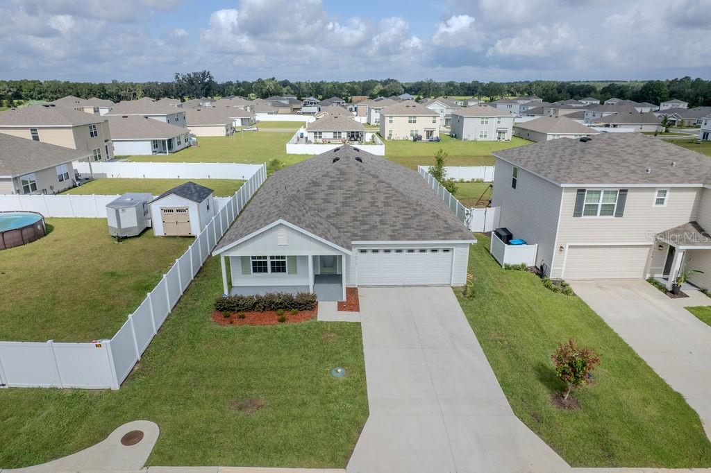 An aerial view of a single-story suburban house with a white garage and driveway — 17070 NW 176TH WAY, ALACHUA, FL