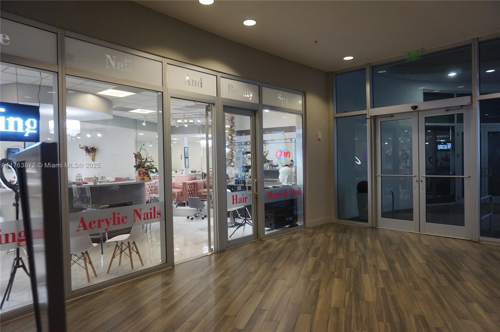 A commercial storefront features glass doors and windows with signage for a nail and beauty spa — 1750 N Bayshore Dr # 2215, Miami FL 33132, MIAMI, FL