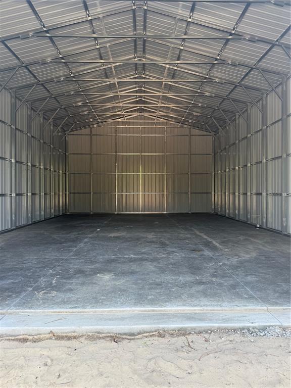 A white house with a two-car garage and a separate detached metal garage building — 7539 SW 129TH TERRACE ROAD, DUNNELLON, FL