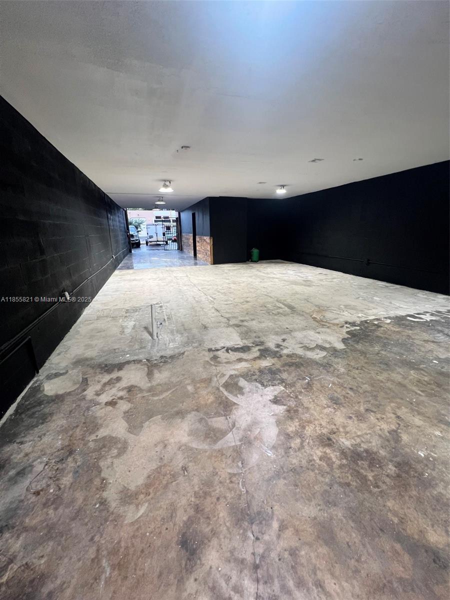 An unfinished interior space features black walls, a concrete floor, and recessed lighting — 1657 W 40th St # 6, Hialeah FL 33012, HIALEAH, FL