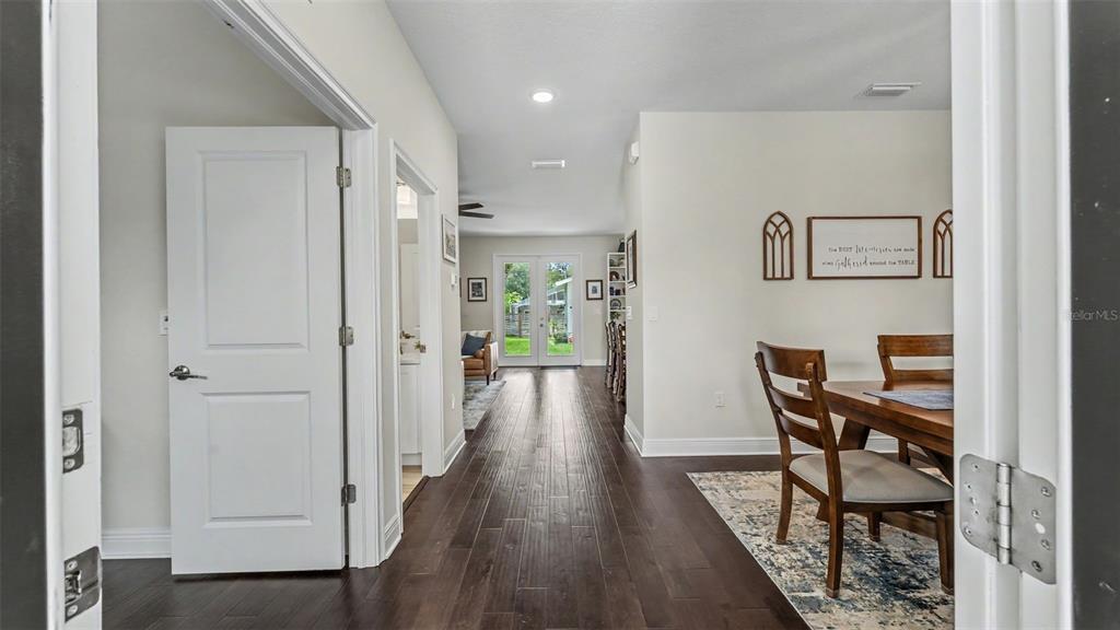 A view from a doorway looking into a dining area with dark wood flooring — 1829 CHEROKEE TRAIL, LAKELAND, FL