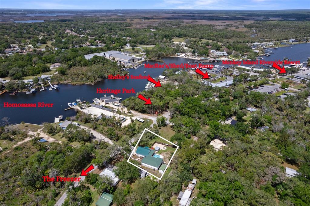 This aerial view shows a residential property with a pool near the Homosassa River — 5447 S BOULEVARD DRIVE, HOMOSASSA, FL