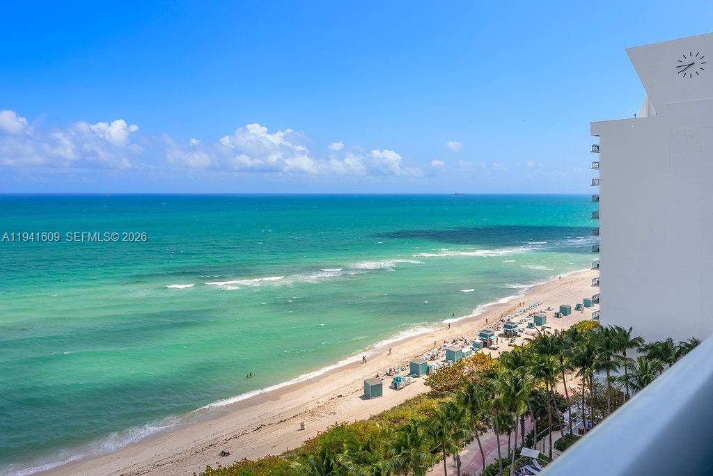 An elevated view of a sandy beach, turquoise ocean, and a high-rise building — 6899 Collins Ave # 1205, Miami Beach FL 33141, MIAMI BEACH, FL