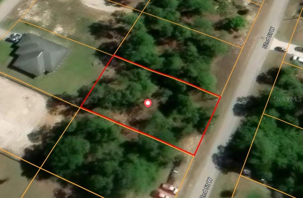 An aerial map view shows a rectangular, wooded vacant lot outlined in red — 2706 52ND STREET W, LEHIGH ACRES, FL
