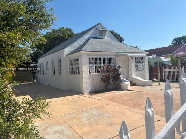 A white, single-story house with a gabled roof and security bars on the windows — 34 NW 69th St, Miami FL 33150, MIAMI, FL