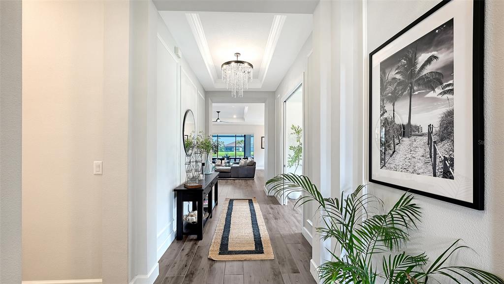 A paved walkway leads to the entrance of a house with a garage and landscaping — 3022 VITTORIO COURT, BRADENTON, FL