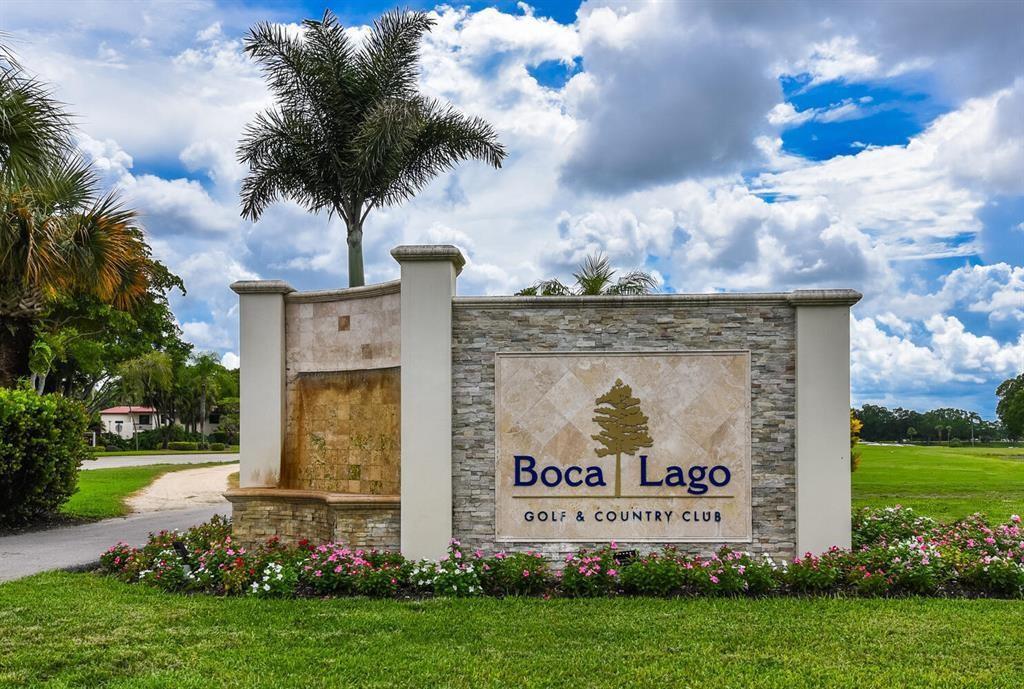 A stone monument sign for Boca Lago Golf & Country Club stands on a lawn — 21542 Juego Circle # 27h, Boca Raton FL 33433, BOCA RATON, FL