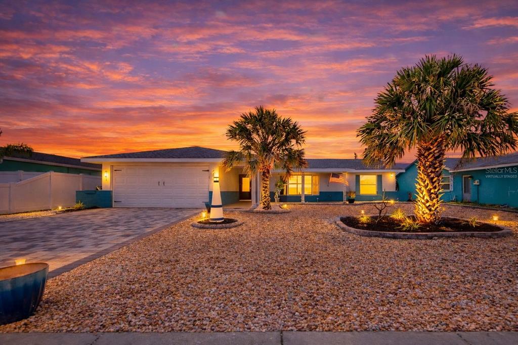 A single-story house with a gravel yard, two palm trees, and a sunset sky — 6512 SENEGAL PALM WAY, APOLLO BEACH, FL