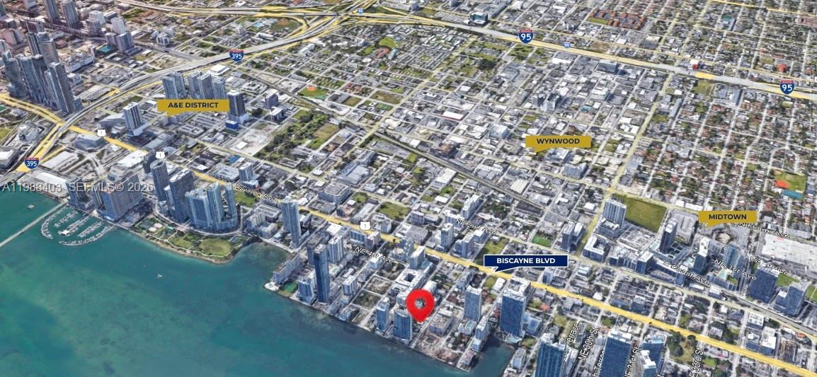 An aerial map view shows a red pin marking a waterfront property in Miami — 702-708 NE 26th St, Miami FL 33137, MIAMI, FL