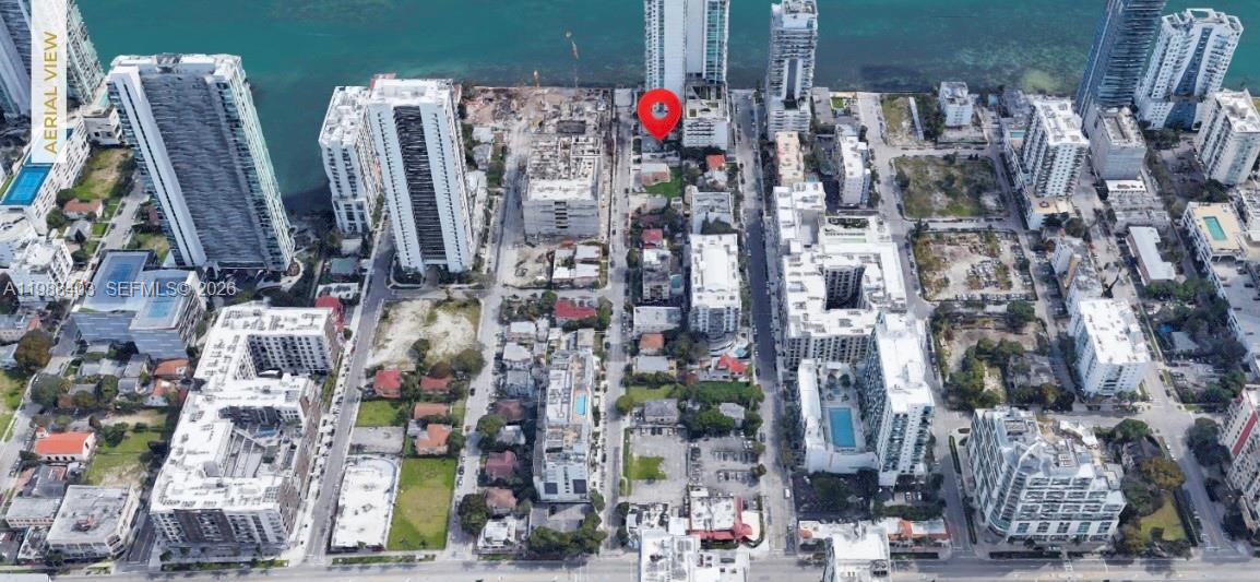 An aerial view shows a red pin marking a property in a dense urban coastal neighborhood — 702-708 NE 26th St, Miami FL 33137, MIAMI, FL
