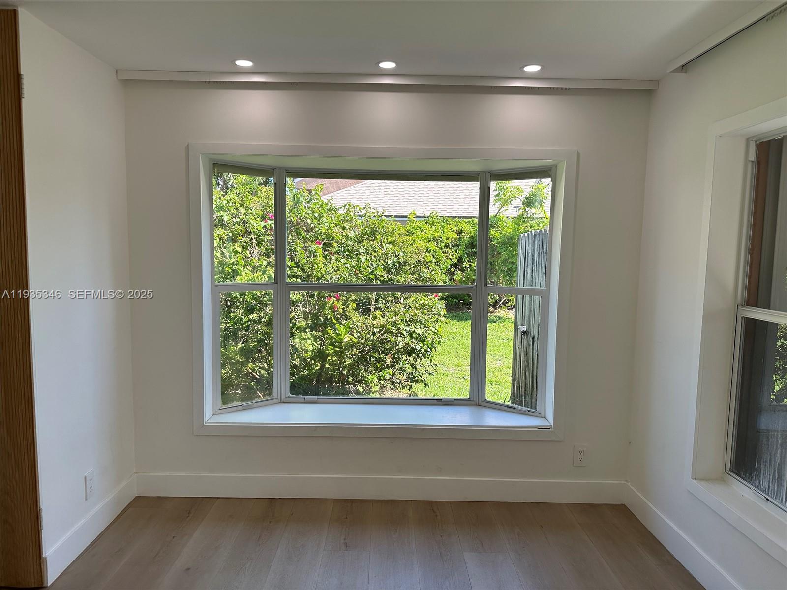 A room with light wood flooring, white walls, recessed lighting, and a large bay window — 708 SE 3rd Ave Ext # 201, Hallandale Beach FL 33009, HALLANDALE BEACH, FL