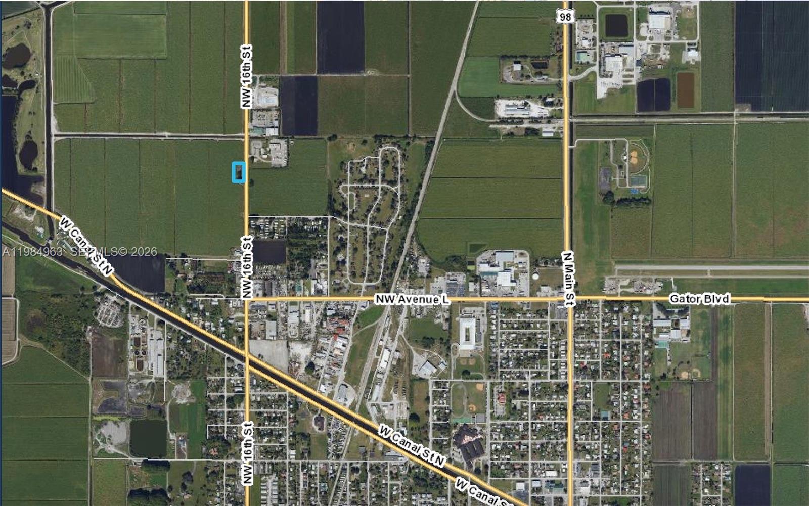 This is an aerial map showing a rectangular property highlighted in blue near agricultural fields — N State Road 715, Belle Glade FL 33430, BELLE GLADE, FL