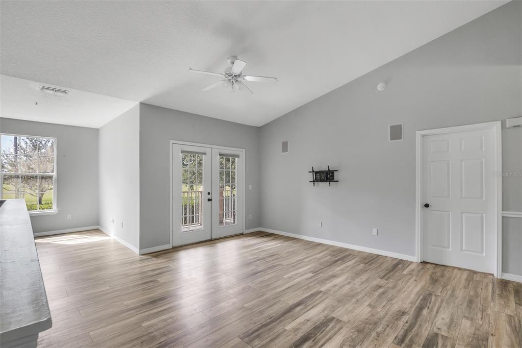 A stone monument sign for Capri at Hunters Creek Condominiums stands amidst trees and landscaping — 14226 FREDRICKSBURG DRIVE UNIT 220, ORLANDO, FL