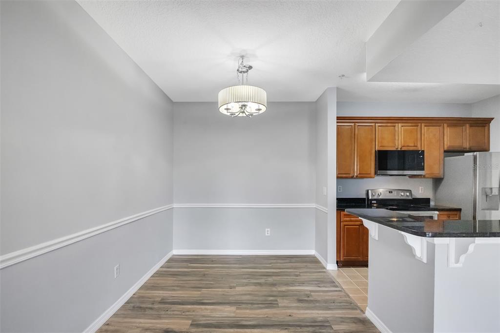 A straight staircase with carpeted steps and a white handrail leads to an upper landing — 14226 FREDRICKSBURG DRIVE UNIT 220, ORLANDO, FL