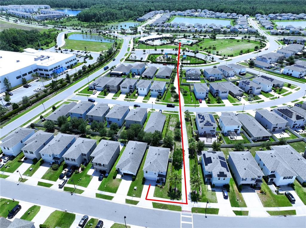 An aerial view shows a suburban neighborhood with a red line highlighting a property path — 16599 SECRET MEADOW DRIVE, ODESSA, FL