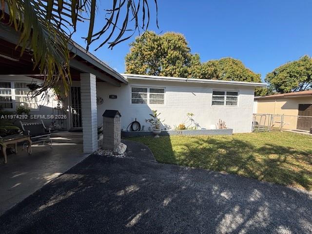 A single-story house with a white exterior, a covered porch, and a front lawn — 15 NE 130th St, North Miami FL 33161, NORTH MIAMI, FL