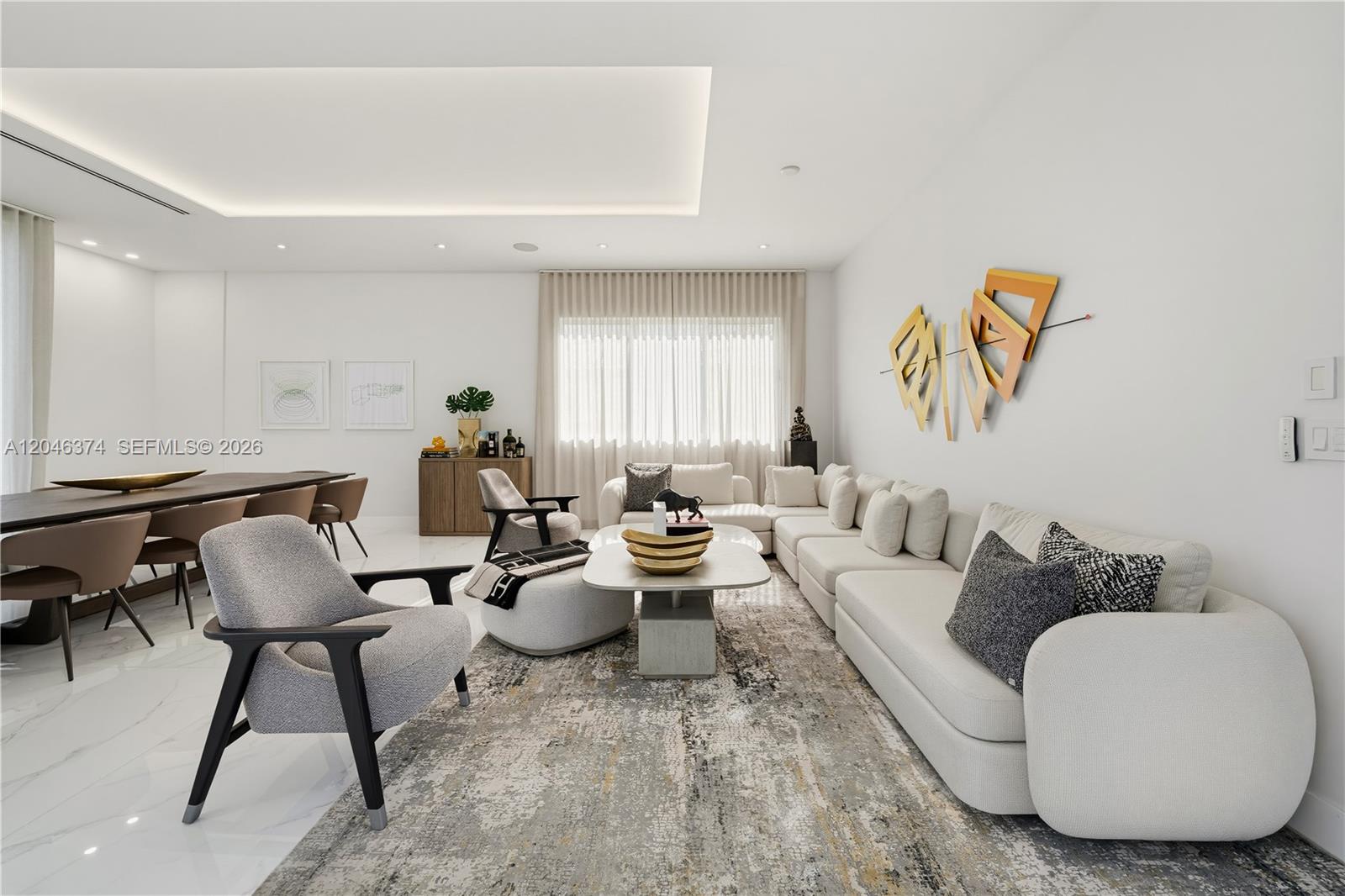 A modern living room features a large sectional sofa, a patterned rug, and dining area — DORAL, FL