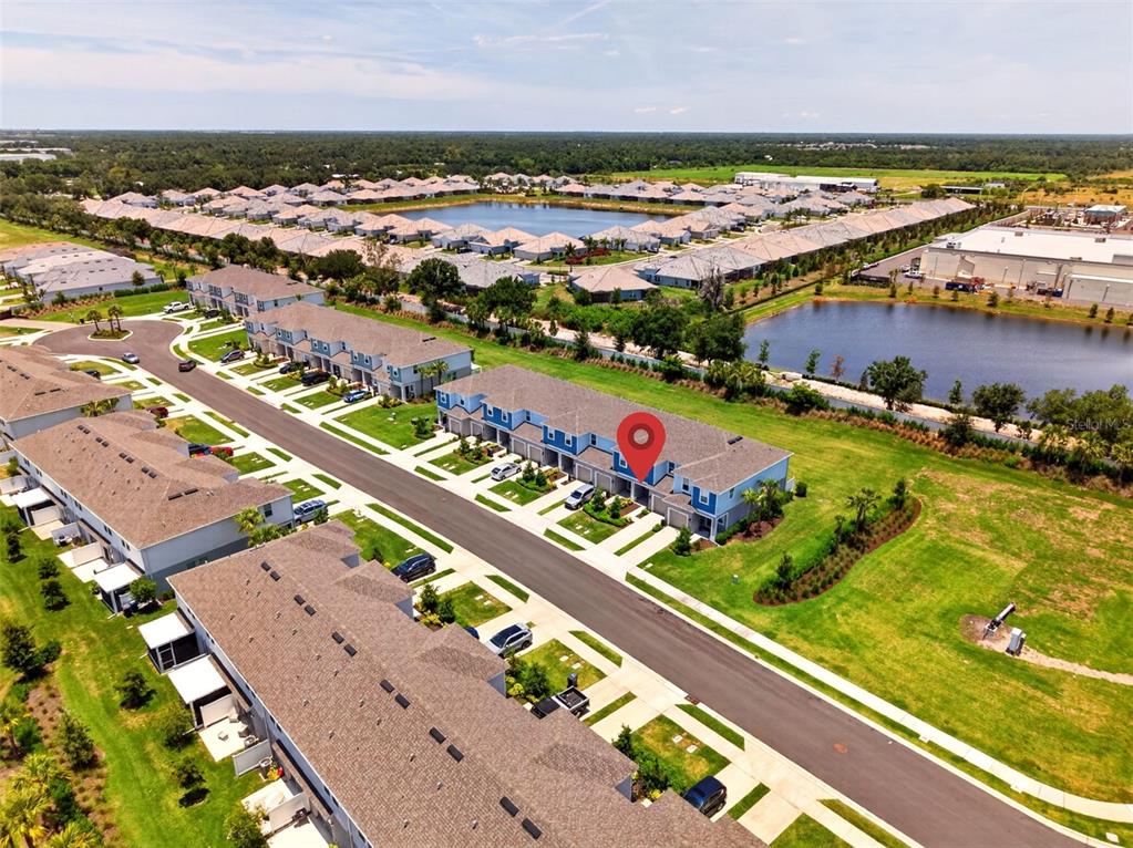 An aerial view shows a residential neighborhood with townhomes, a pond, and a red pin — 16637 BERGAMO PLACE, BRADENTON, FL